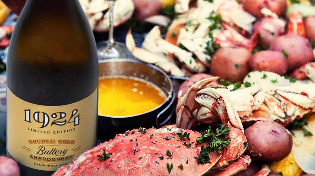 Bottle of 1924 Buttery Chardonnay with seafood.