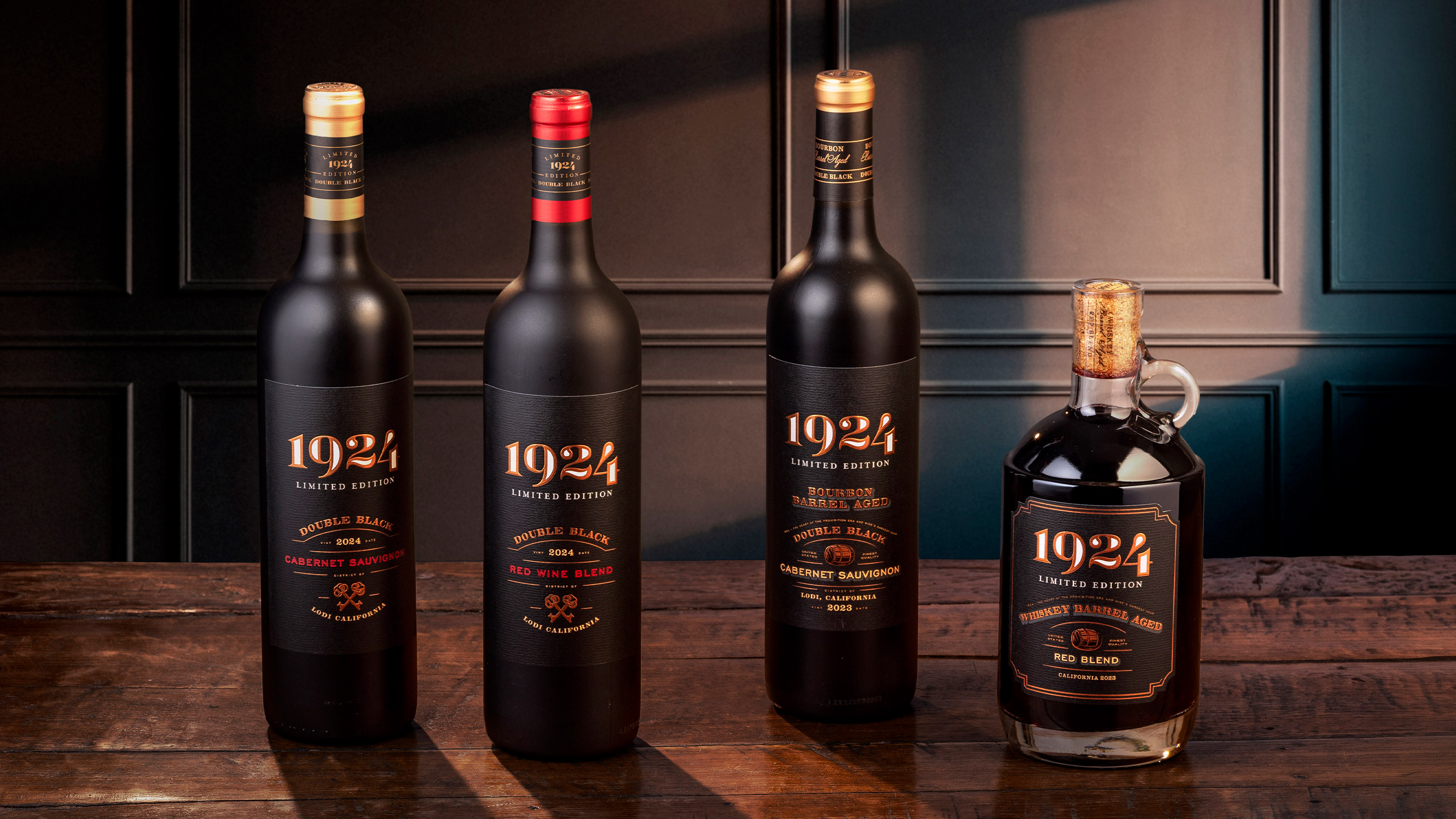 A dark moody image of 1924's lineup of wines on a wood counter